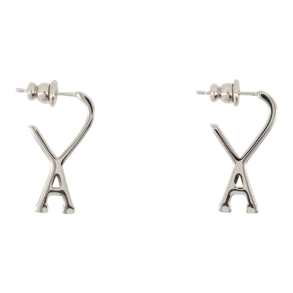 Boucles d'oreilles en métal argenté - Portées avec deux oreilles